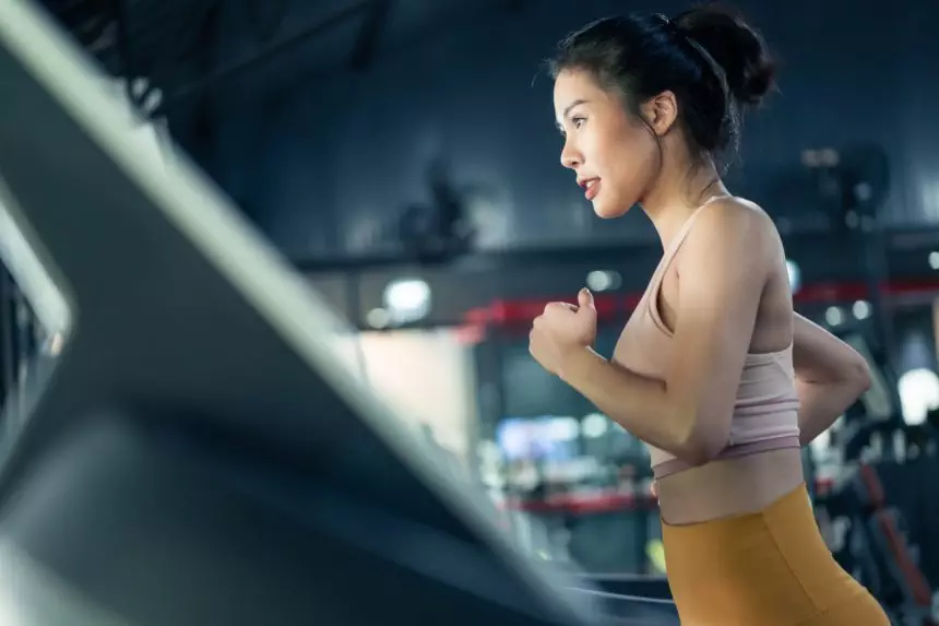 Asian athlete sportswoman practice workout exercise by run on Treadmill to burns calories in gym