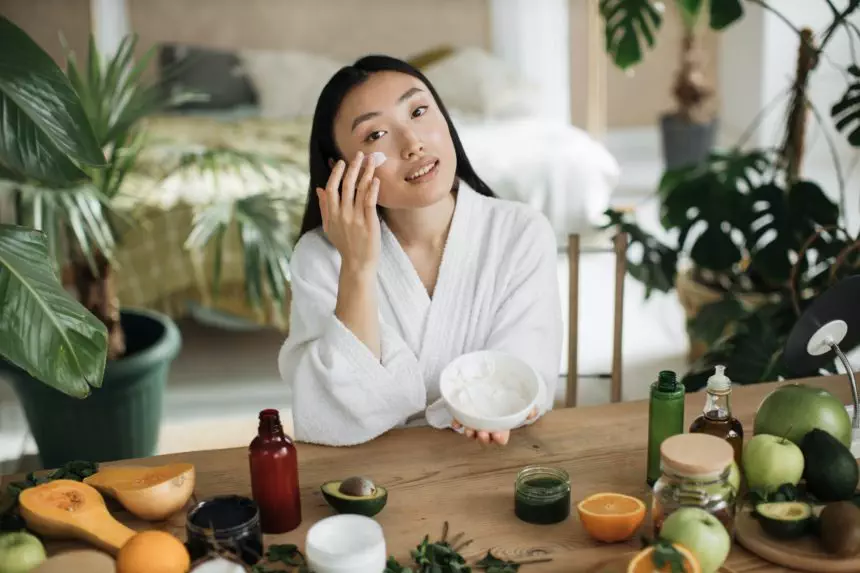 Beautiful asian woman preparing homemade cream with natural ingredients for skin care
