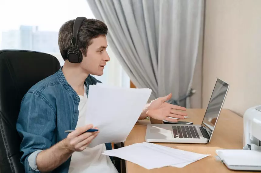 Cheerful man works and studies remotely from home