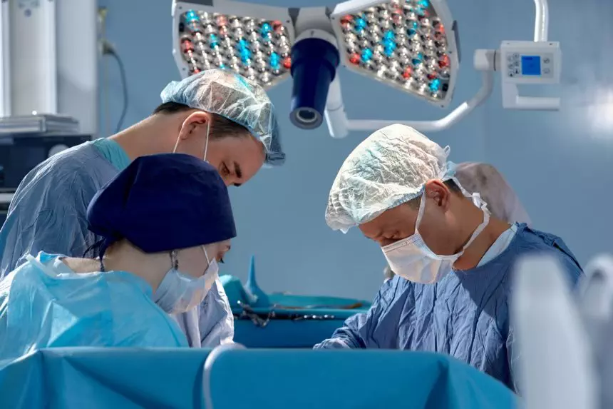 faces of surgeons in the operating room during the operation. Modern medicine, medical workers